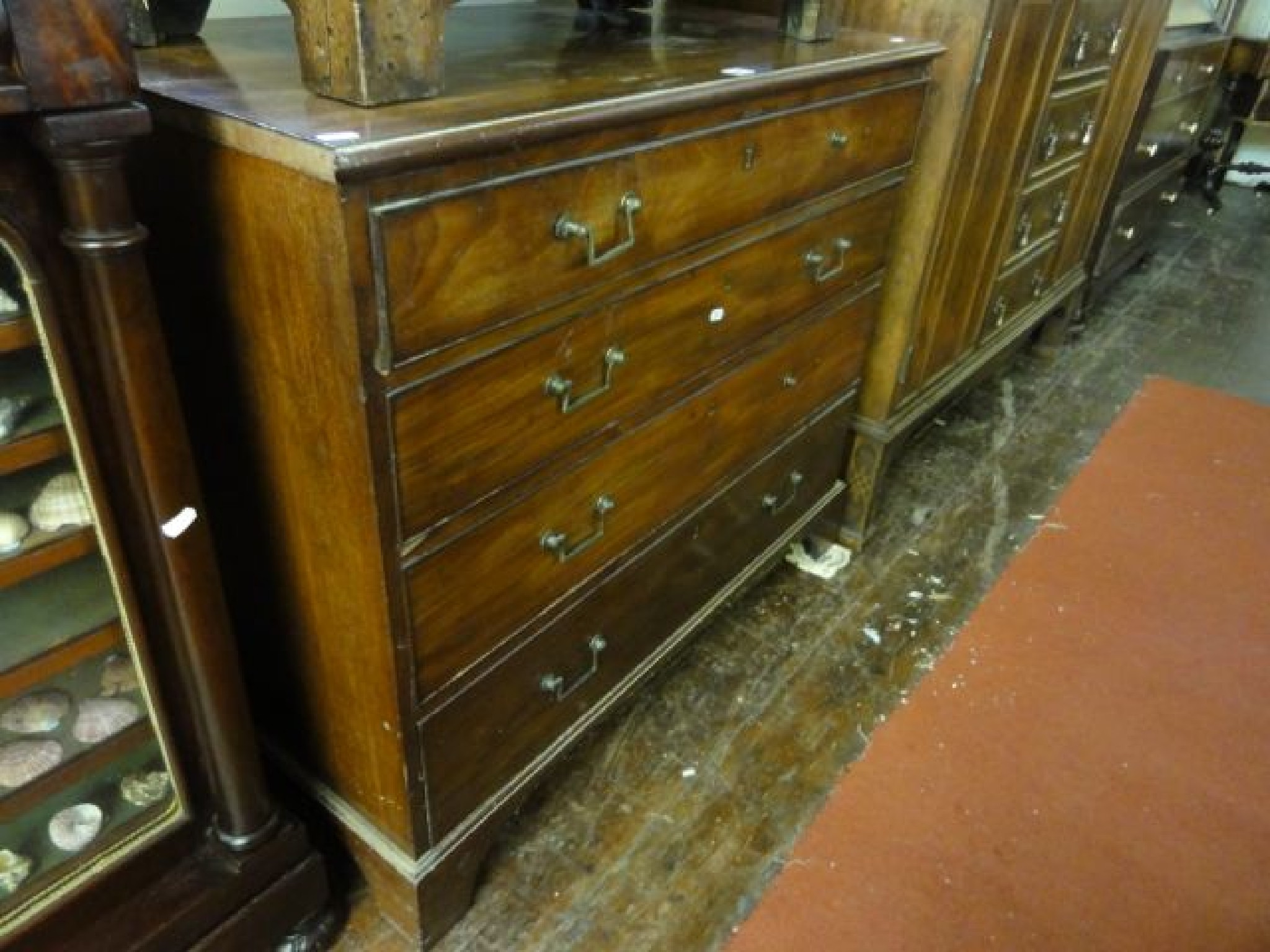 Appraisal: A simple Georgian mahogany chest of four long graduated drawers