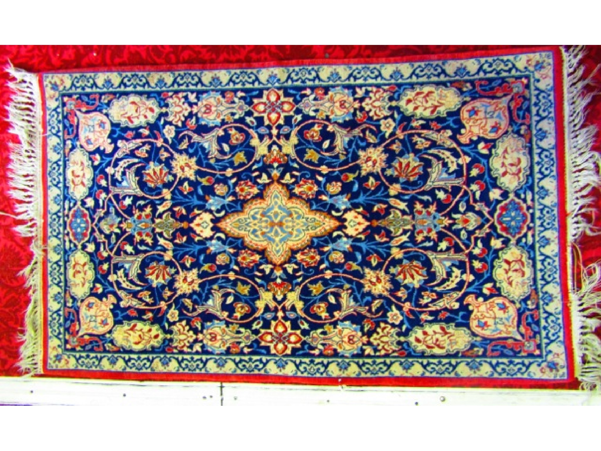 Appraisal: A small eastern wool rug with deep blue field decorated