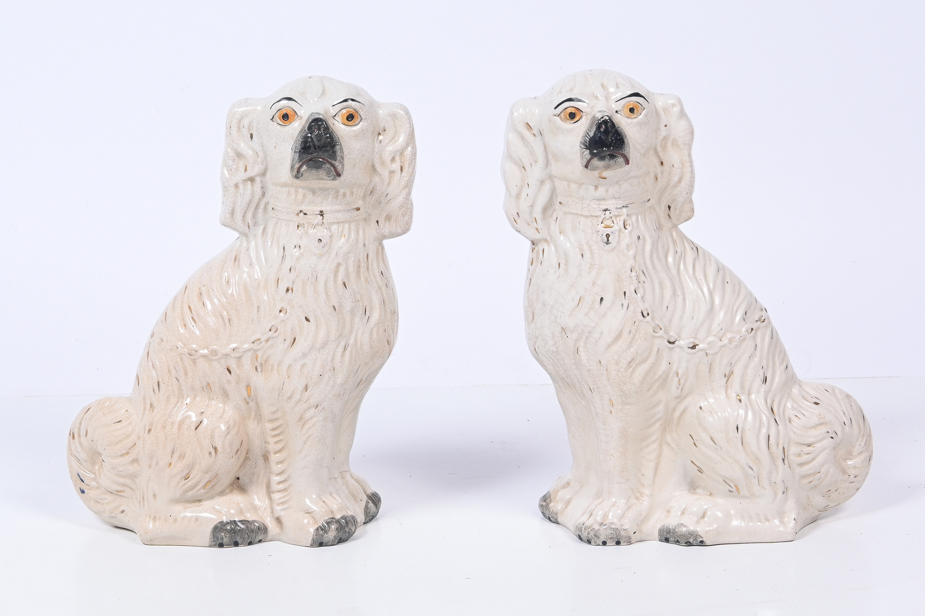 Appraisal: PAIR ENGLISH STAFFORDSHIRE PORCELAIN DOGS Opposing th-century Staffordshire porcelain Spaniels