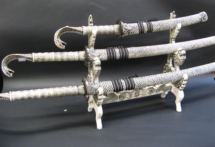 Appraisal: GROUP CHINESE SWORDS AND DISPLAY STAND decorated in a scrimshawed