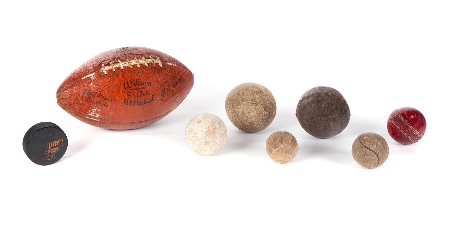 Appraisal: GROUP OF AMERICAN BASEBALLS FOOTBALL PUCK Twentieth century Leather Wilson