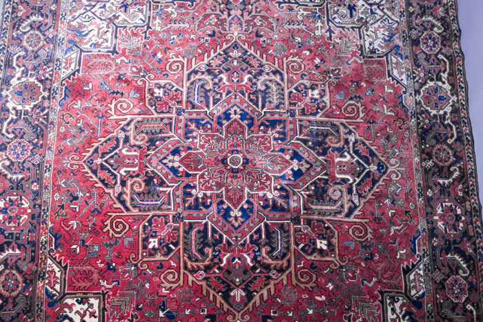 Appraisal: HERIZ CARPET NORTHWEST PERSIA The angular lobed midnight blue medallion