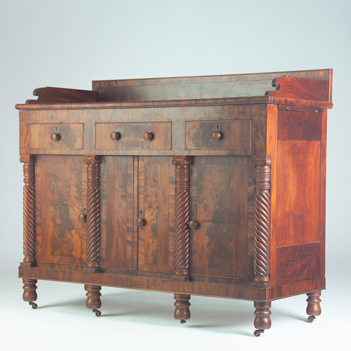 Appraisal: American Empire mahogany and burl veneer sideboard decorated with four