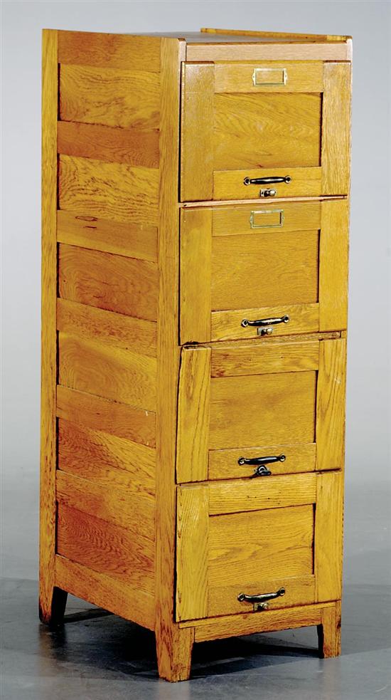 Appraisal: Oak four-drawer file cabinet th century frame-and-panel construction with vertical