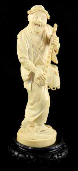 Appraisal: Japanese Ivory Okimonoof an old musician holding a stringed instrument