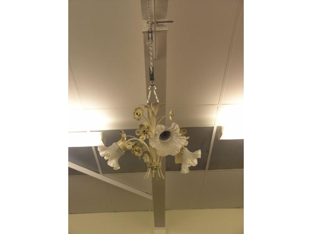 Appraisal: A cream-painted tinplate chandelier floral design with three glass shades