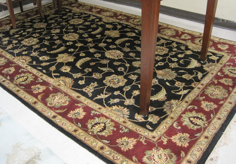 Appraisal: HAND KNOTTED ORIENTAL CARPET Indo-Persian the rectangular black field and