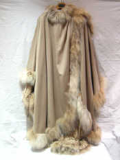 Appraisal: A beige cape the edges and neck trimmed with fox