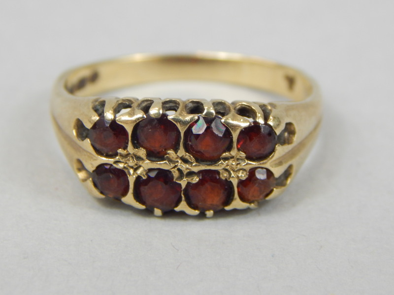 Appraisal: A ct gold dress ring set with eight red stones