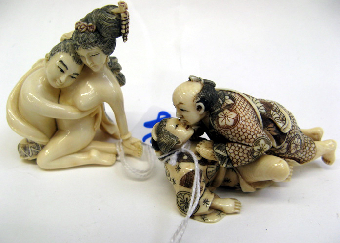 Appraisal: TWO EROTIC JAPANESE IVORY CARVED NETSUKE male and female figures