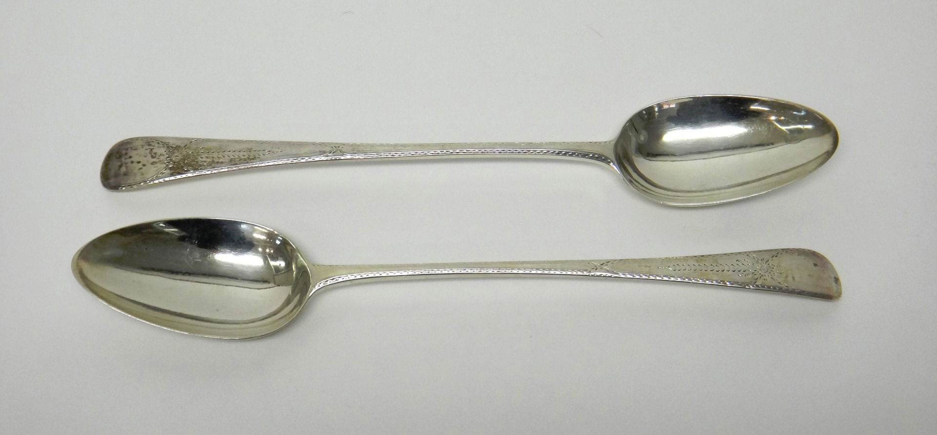 Appraisal: A pair of George III silver stuffing spoons Old English