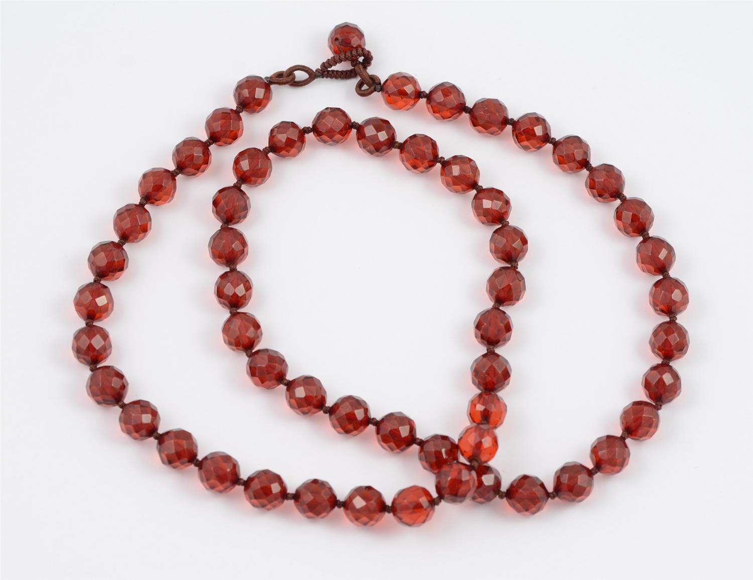 Appraisal: Faceted Cherry Amber Necklace Strung on Silk long