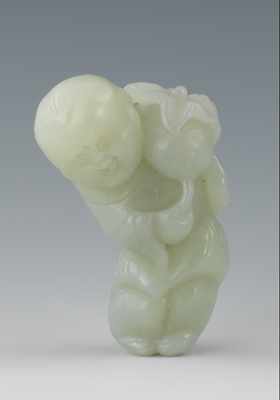 Appraisal: A Chinese Carved Jade of a Boy with a Pomegranate