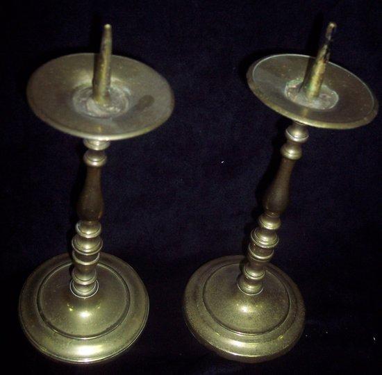 Appraisal: A pair of brass pricket candlesticks on turned columns and