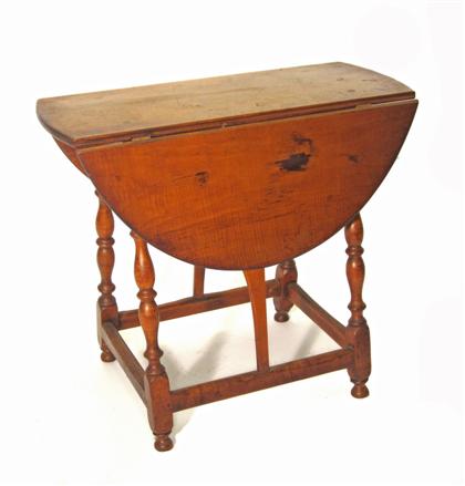 Appraisal: Tiger maple butterfly table new england th th century