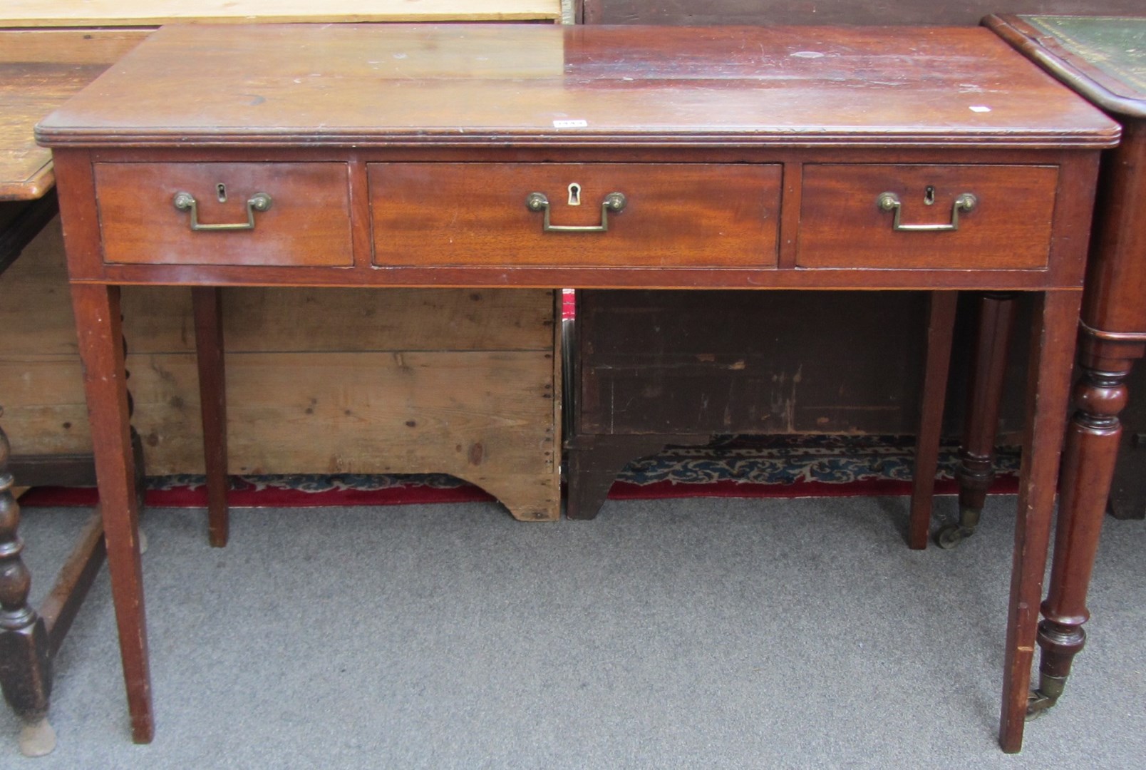 Appraisal: A George III mahogany rectangular three drawer writing table on