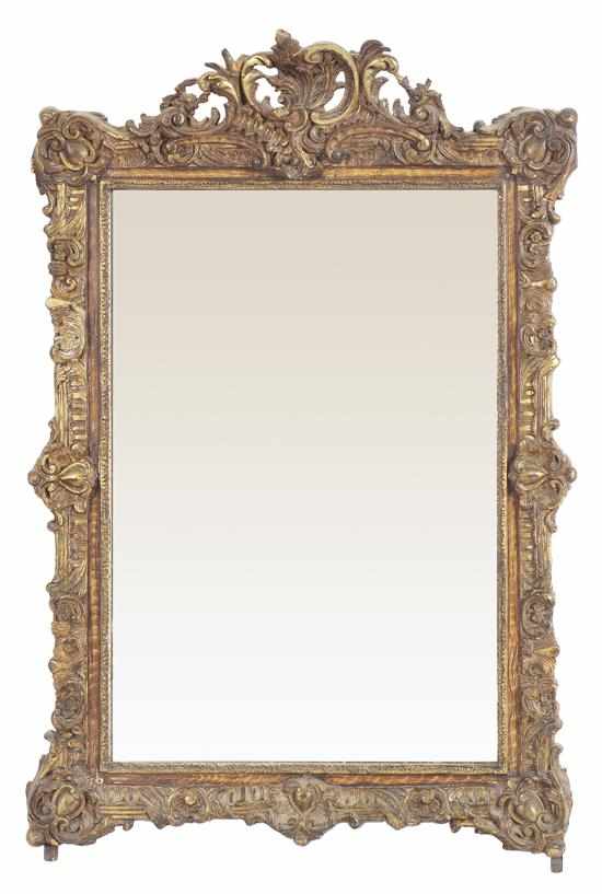 Appraisal: A FRENCH GILTWOOD WALL MIRROR The rectangular plate beneath a