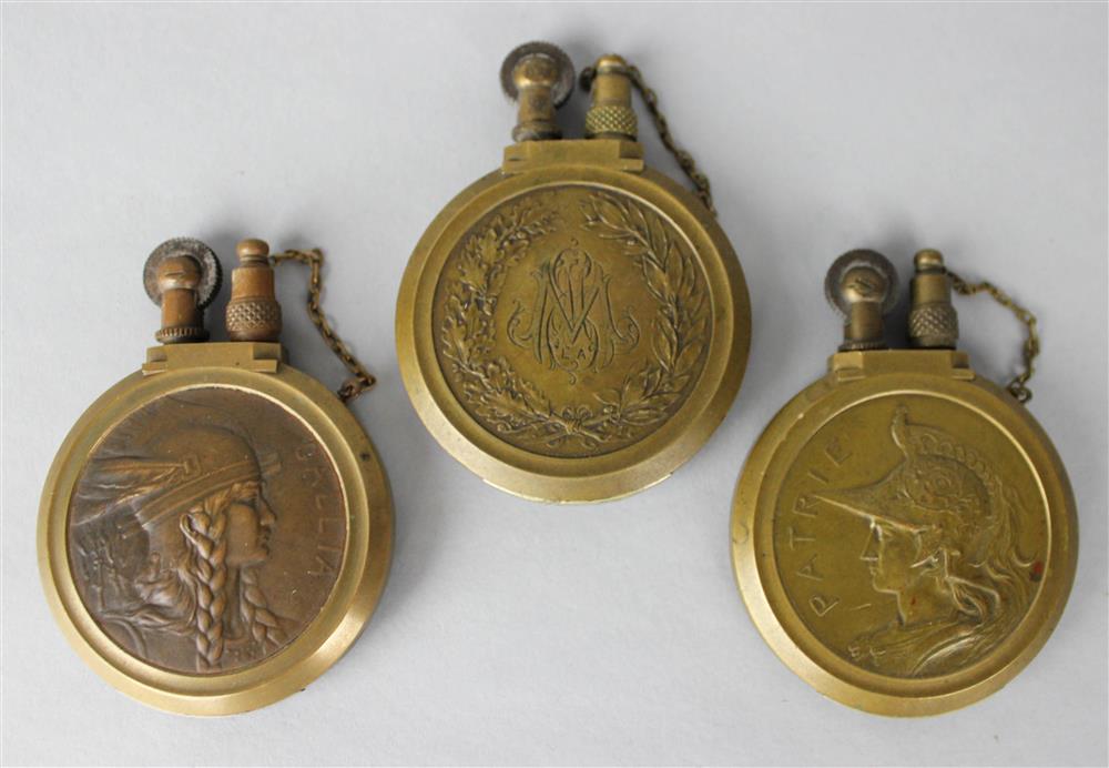 Appraisal: THREE BRONZE LIGHTERS including one titled Patrie - dia in