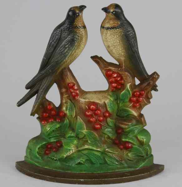 Appraisal: SWALLOWS DOORSTOP Hubley depicts birds perched on holly tree w