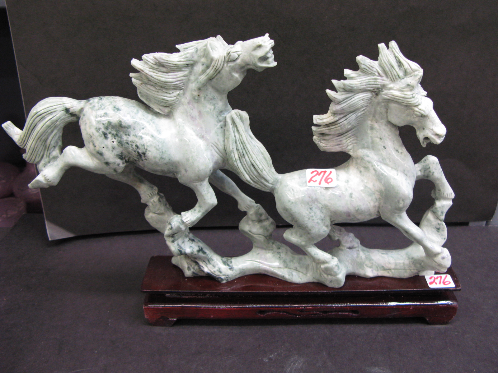 Appraisal: AN APPLE GREEN CARVED CHINESE JADE FIGURAL EQUESTRIAN GROUP apple