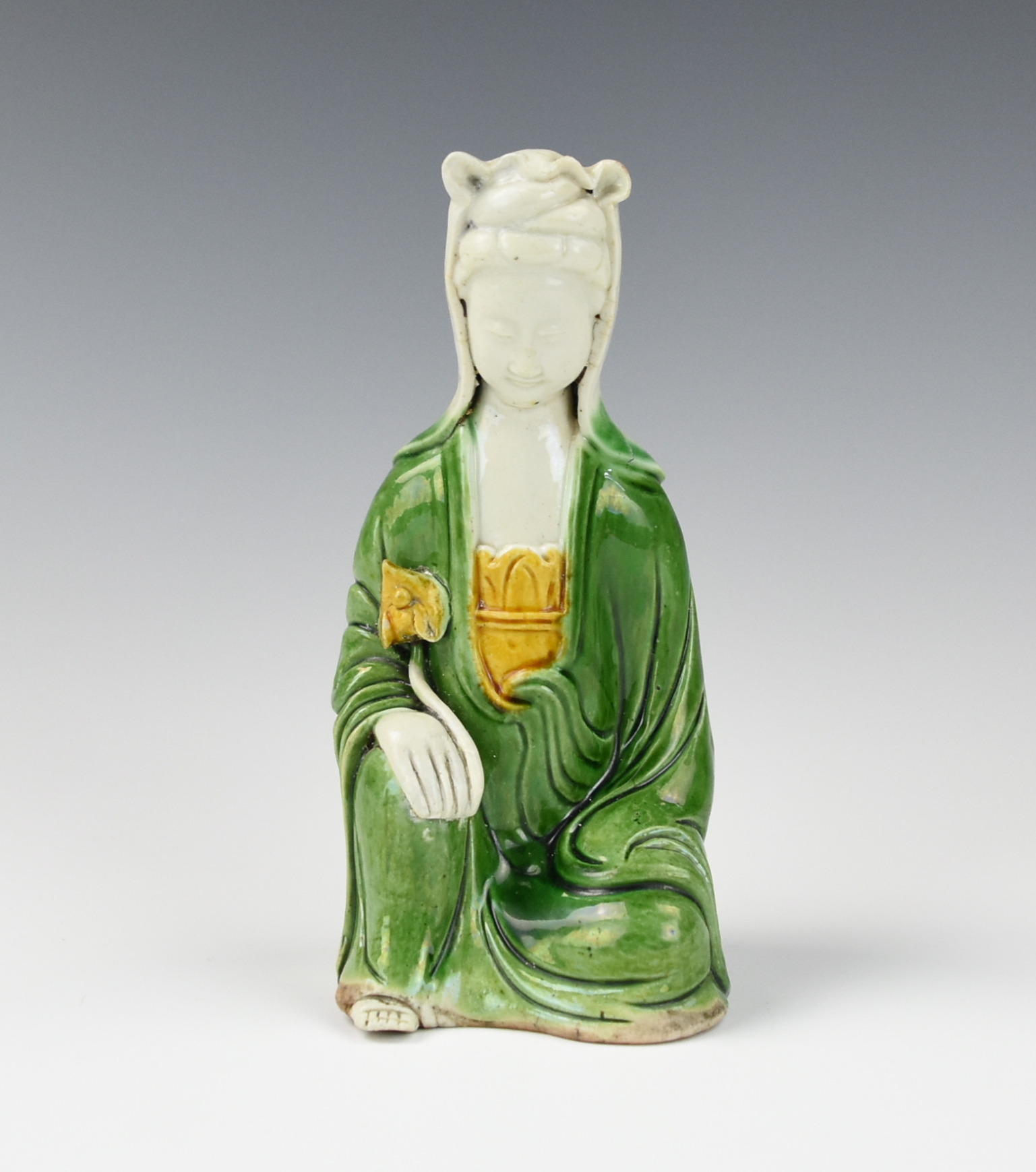 Appraisal: CHINESE SANCAI GLAZED FIGURE OF GUANYIN TH C A Chinese