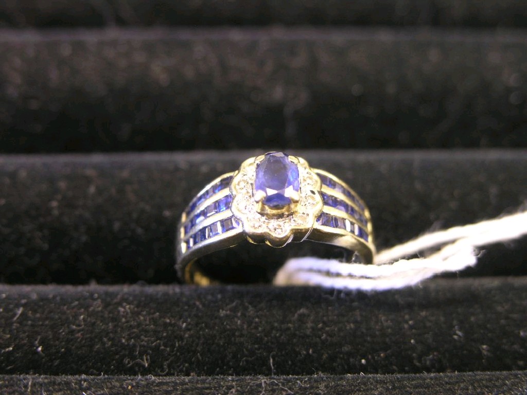 Appraisal: A ct gold diamond and sapphire cluster ring central sapphire