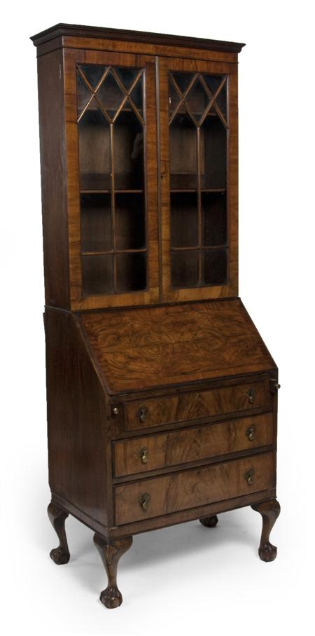 Appraisal: A Georgian style walnut bureau bookcase the projected moulded cornice