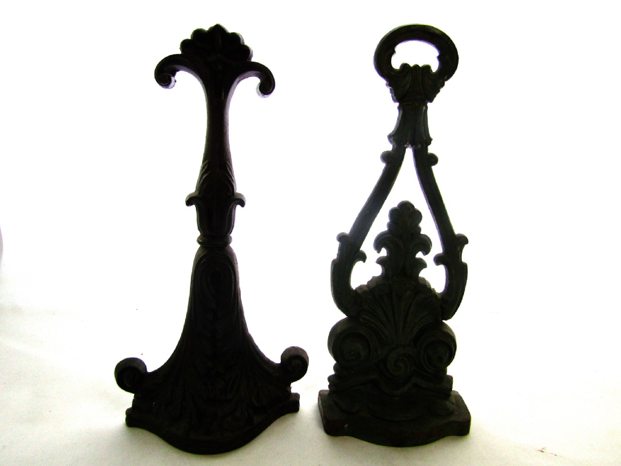 Appraisal: A th century cast iron door stop with moulded acanthus