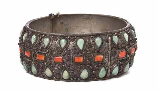 Appraisal: A Sino-Tibetan Silvered and Hardstone Inset Bangle of circular cuff