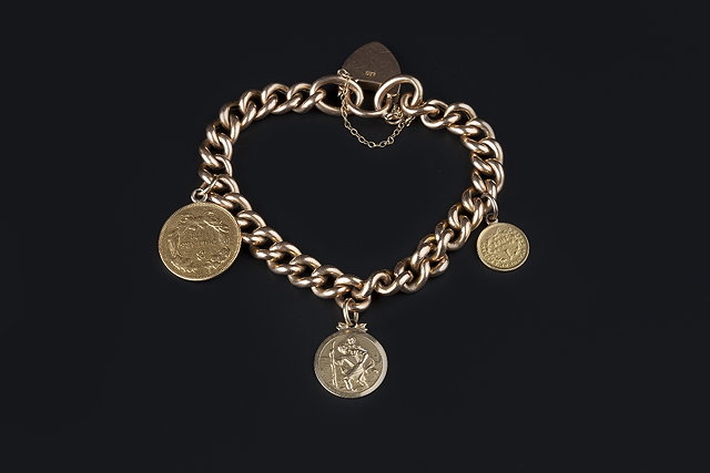 Appraisal: A CURB-LINK BRACELET with padlock clasp stamped ' ' suspending