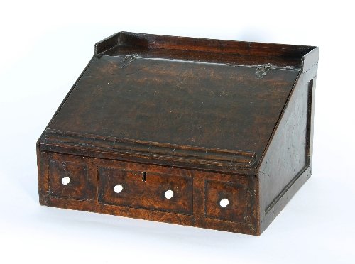 Appraisal: A burr oak writing box with sloping lid concealing two