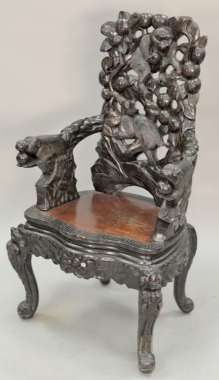 Appraisal: Carved Oriental armchair with carved monkeys and fruit ht in