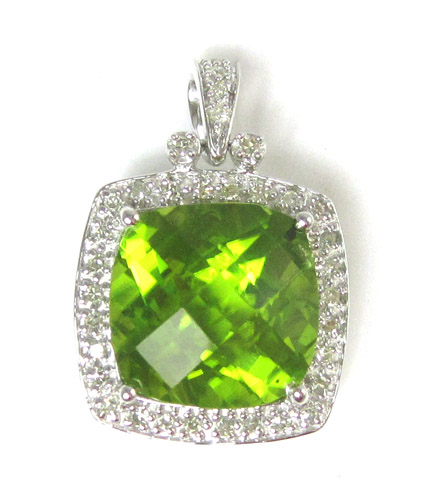 Appraisal: PERIDOT DIAMOND AND TEN KARAT WHITE GOLD PENDANT featuring a