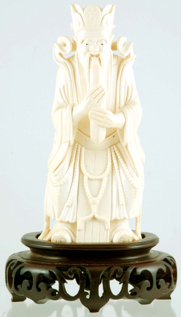 Appraisal: A Japanese carved ivory figure of an elder dressed in