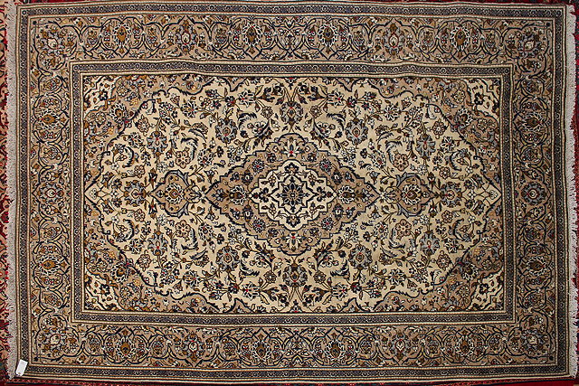 Appraisal: AN EASTERN KASHAN CREAM GROUND RUG with a central motif