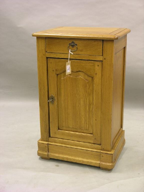 Appraisal: A solid oak medium oak bedside cupboard with drawer above