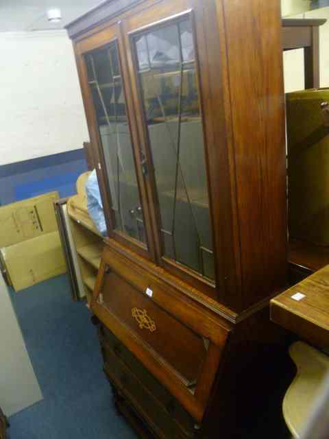 Appraisal: AN EDWARDIAN OAK BUREAU BOOKCASE the upper section enclosed by