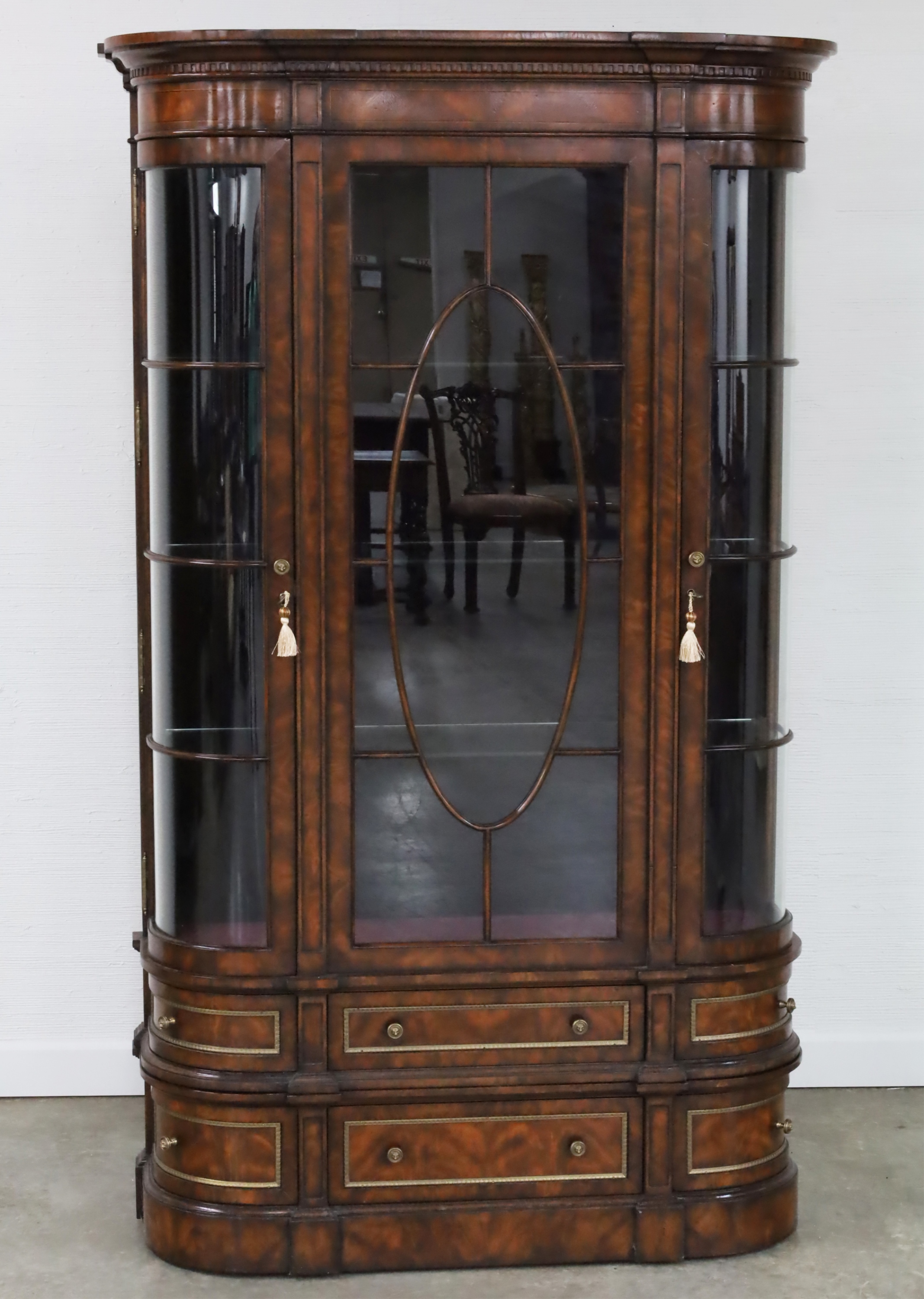 Appraisal: ALTHORPE COLLECTION CROTCH MAHOGANY VITRINE Crotch mahogany bow-end glass front