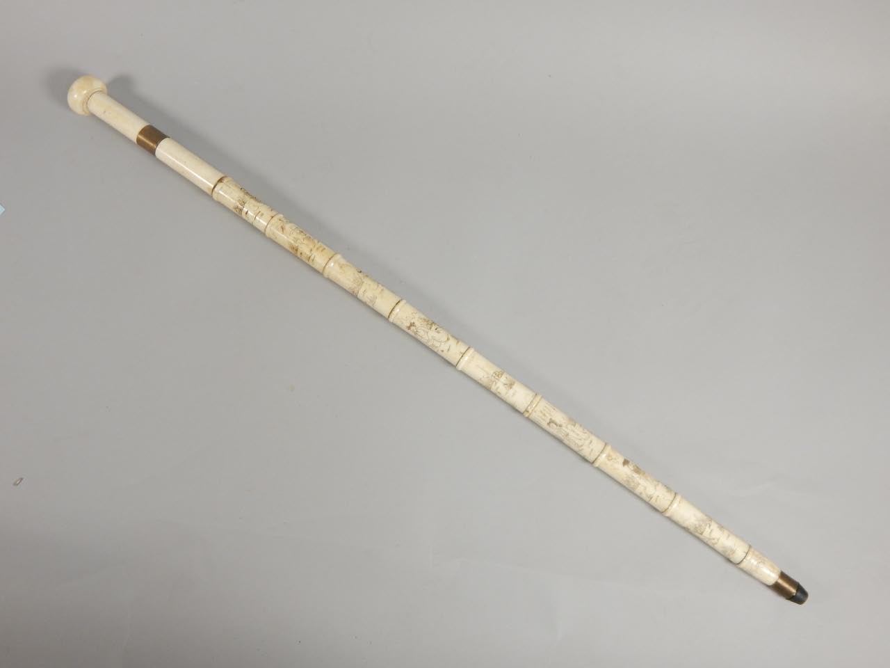 Appraisal: An ebonised walking stick with silver collar the handle mounted