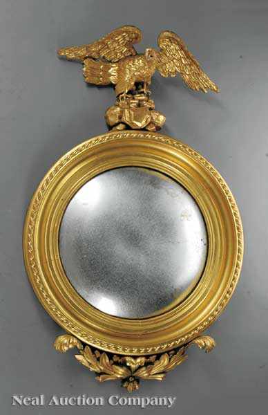 Appraisal: An English Carved and Gilded Convex Mirror c spreadwinged eagle