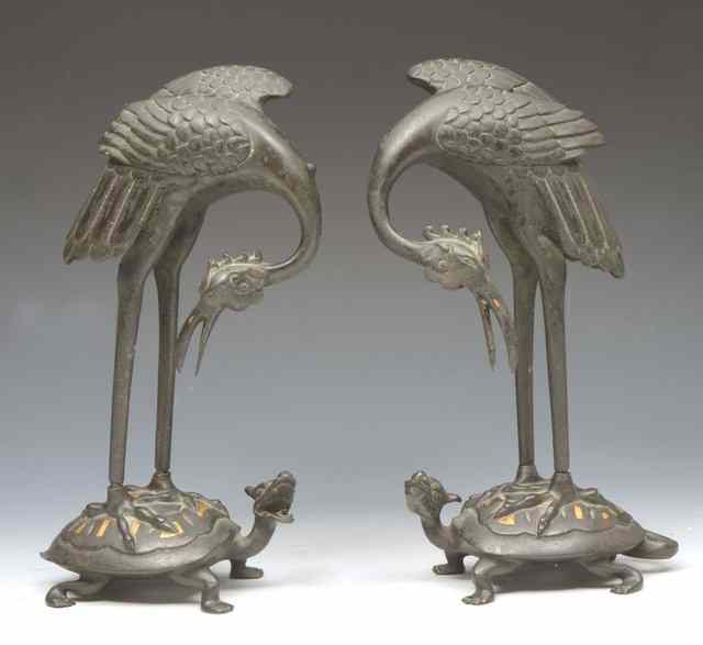 Appraisal: A PAIR OF CHINESE BRONZE AND GILT JOSS STICKS modelled