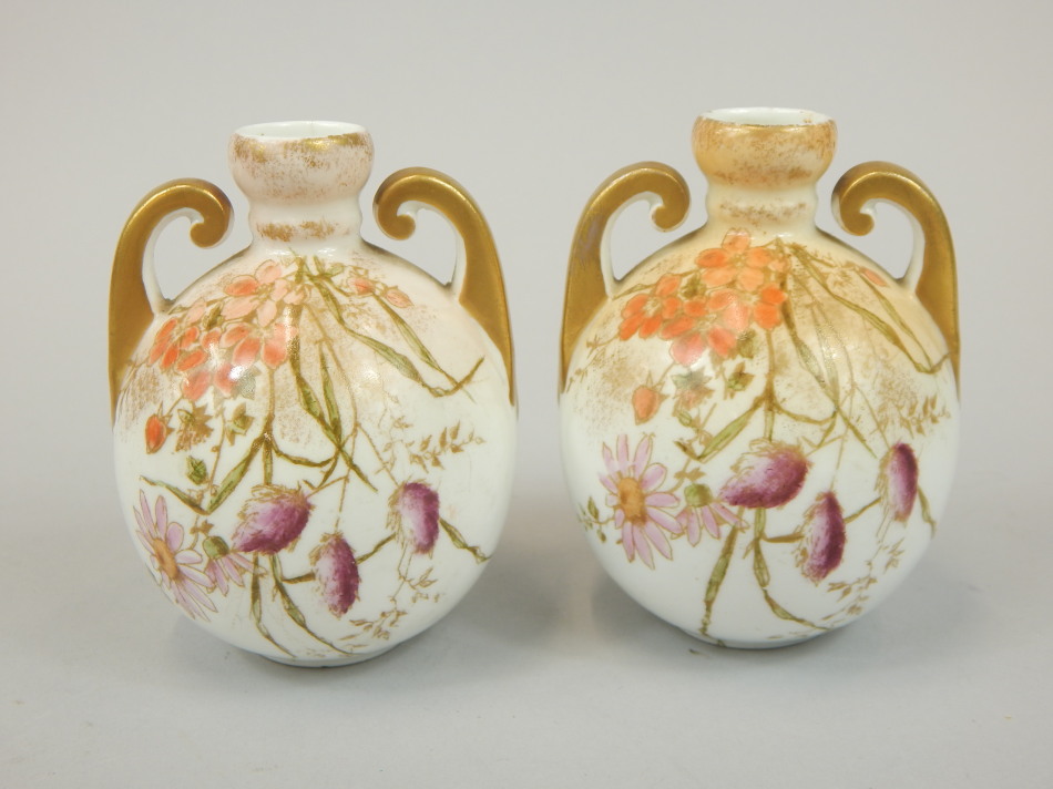 Appraisal: A pair of Staffordshire globular two handled vases each printed