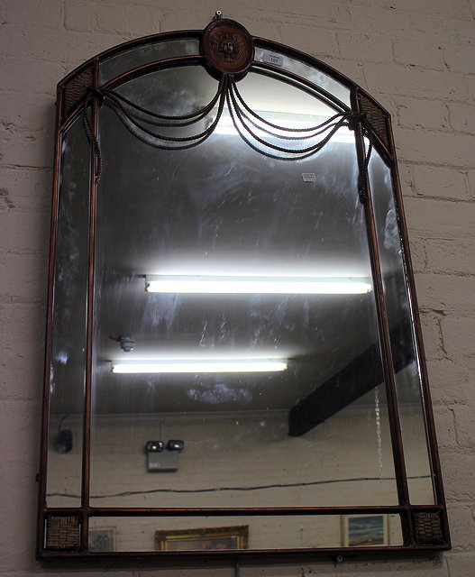 Appraisal: AN ITALIANATE WALL MIRROR with masked crest and swag decoration