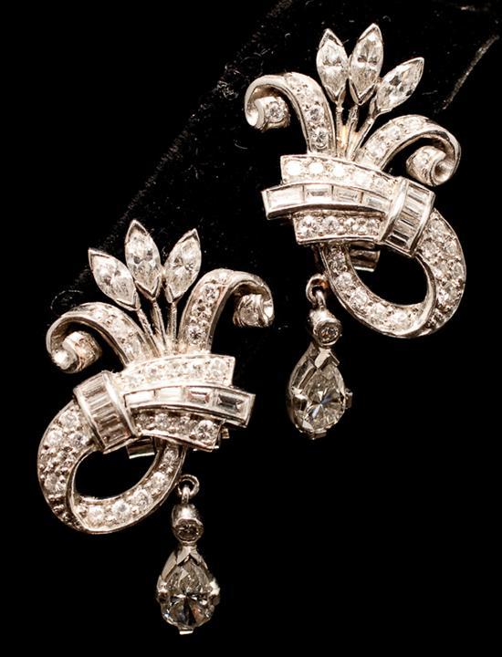 Appraisal: Pair of lady's unmarked white gold and diamond scroll-form clip