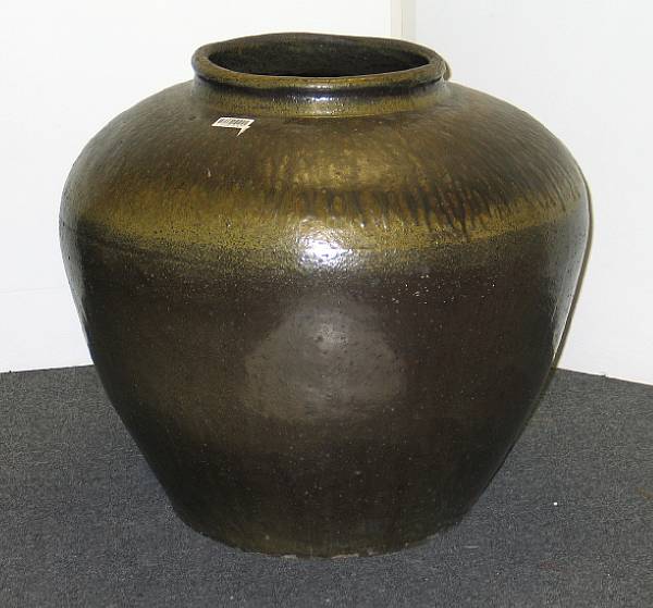 Appraisal: A massive glazed pottery storage jar Possibly of Chinese origin