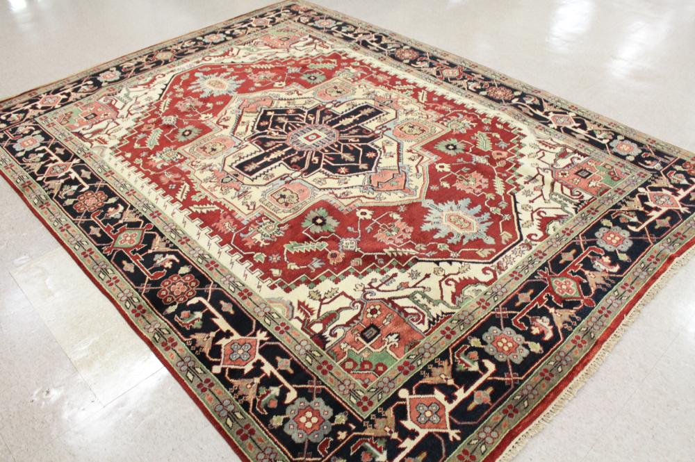 Appraisal: HAND KNOTTED ORIENTAL CARPET Persian Heriz design with red field