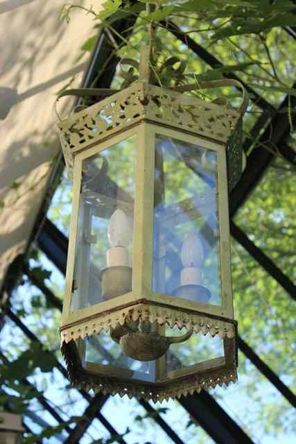 Appraisal: A PAIR OF GREEN PAINTED HEXAGONAL HALL LANTERNS with pierced