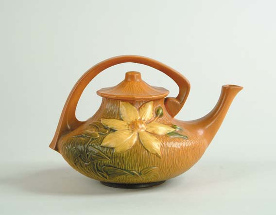 Appraisal: ROSEVILLE CLEMATIS TEAPOT Shape No Roseville mark in relief Orange