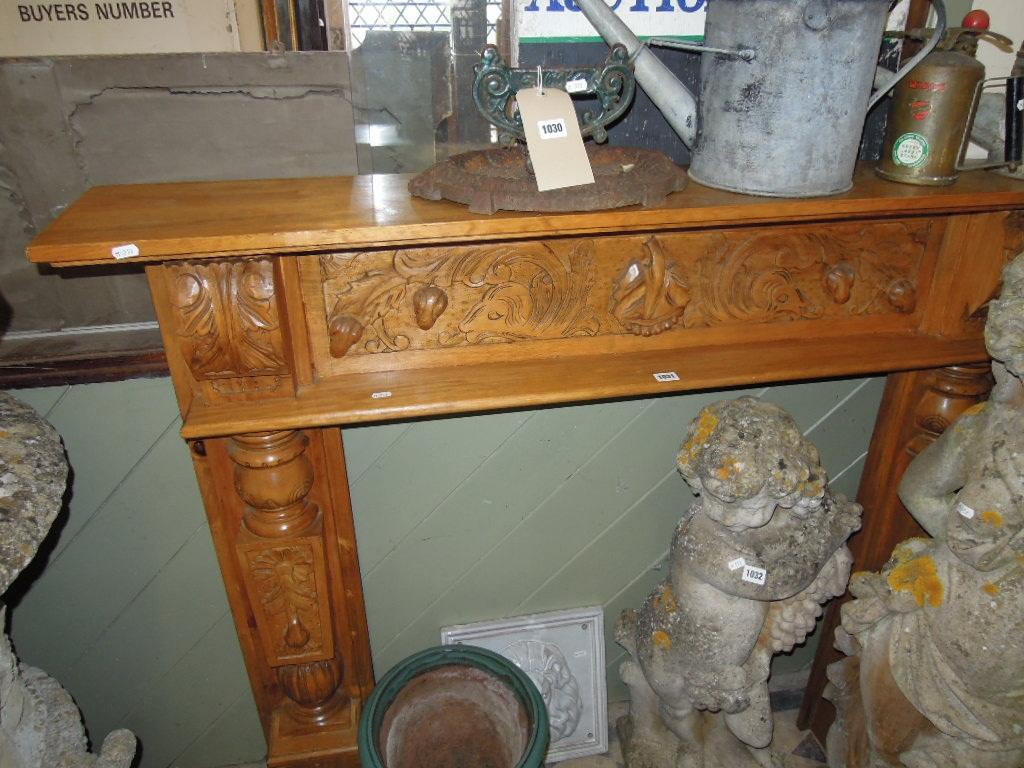 Appraisal: A timber fire surround with carved corbels and scrolling acanthus