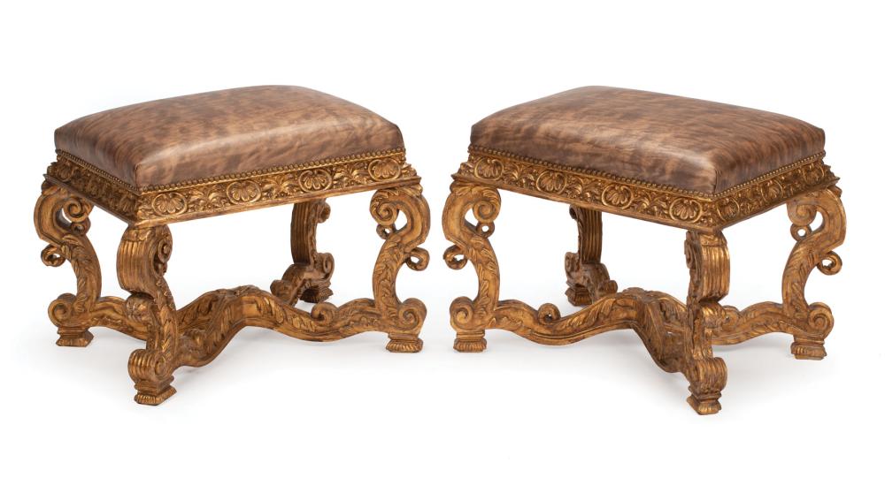 Appraisal: Pair Continental Carved Giltwood Benches leather upholstery foliate S scroll